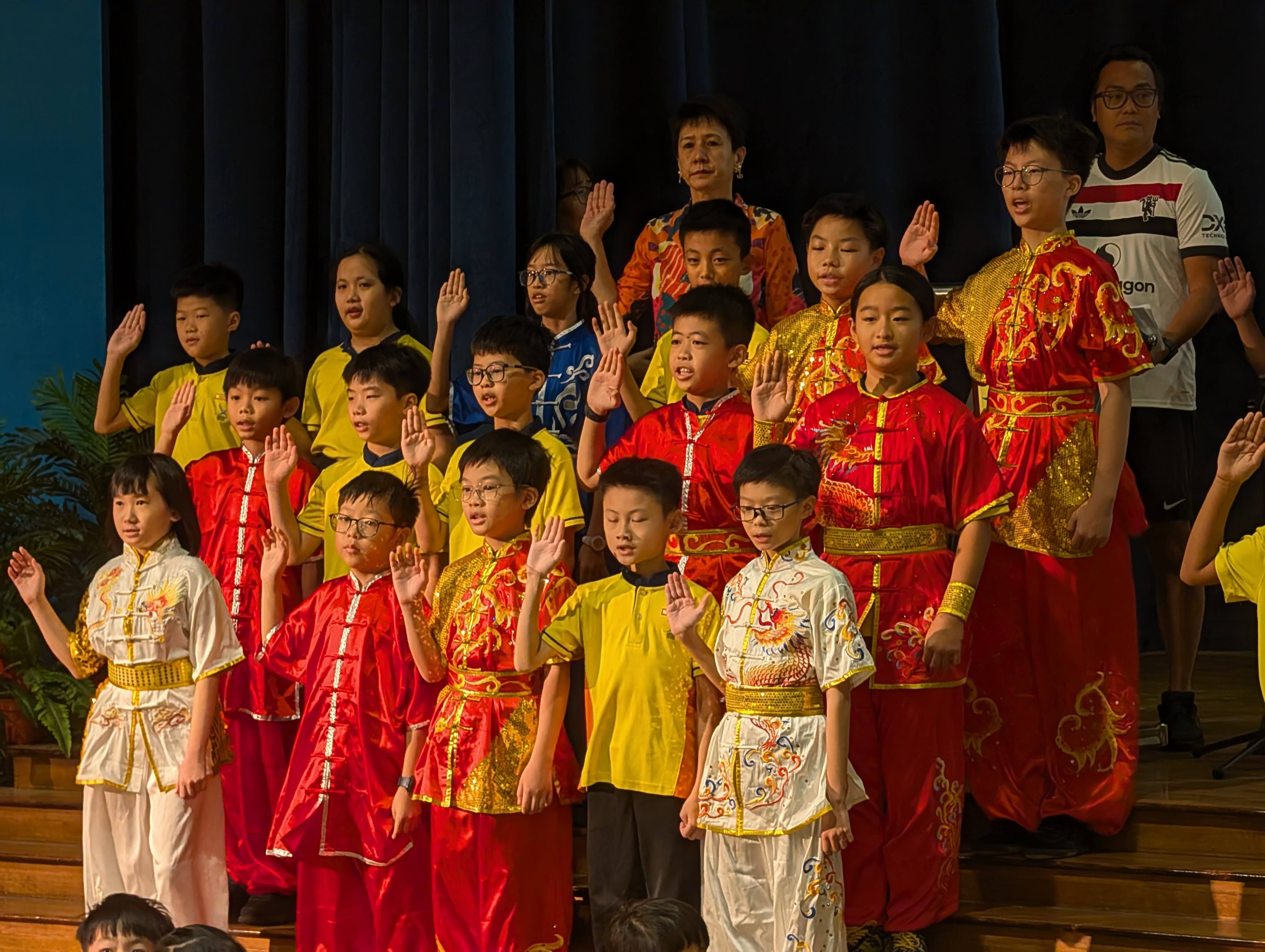 Wushu CCA members taking part in the Athlete's Oath on stage